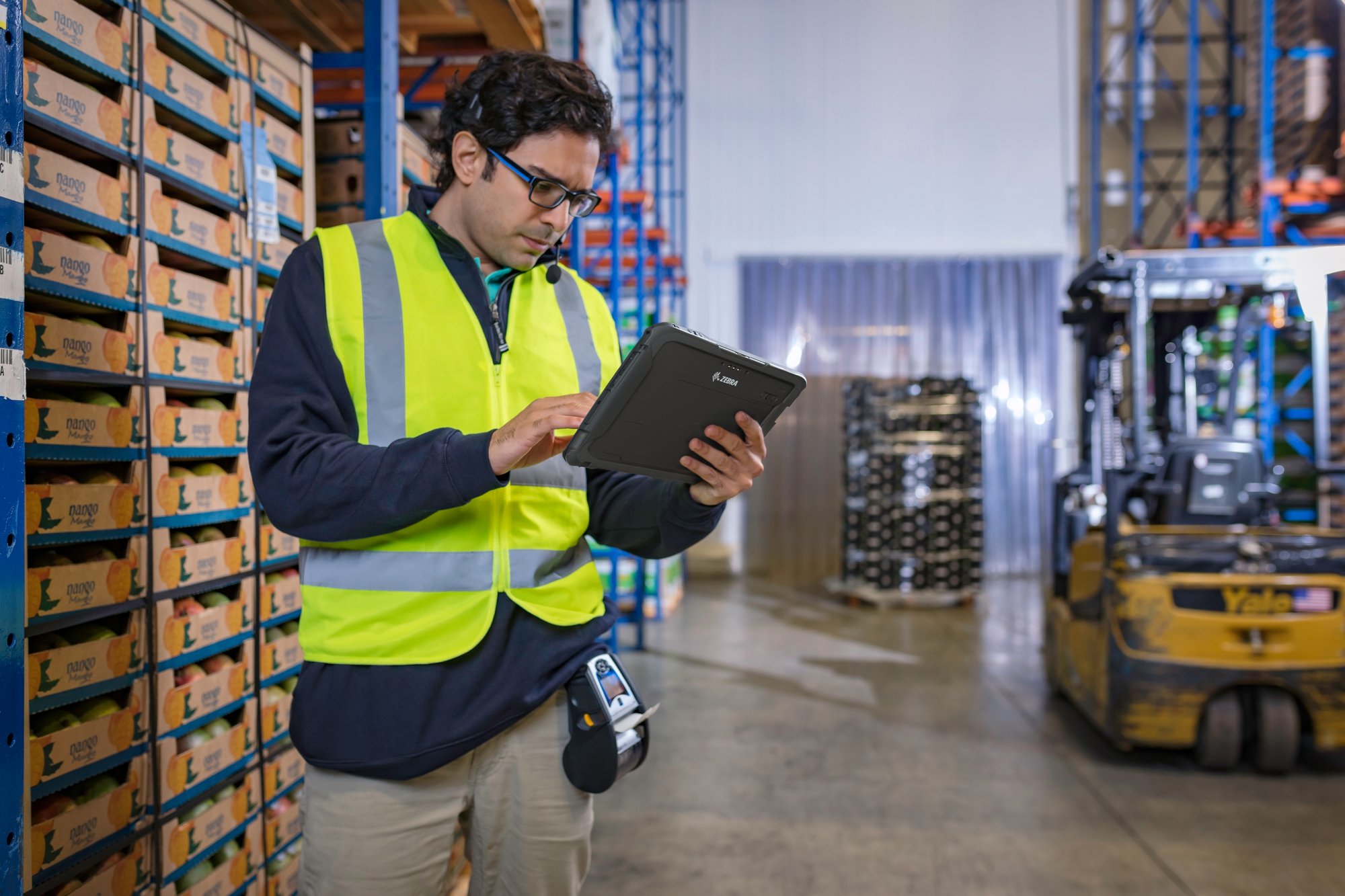 Warehouse worker using a Zebra Technologies tablet to check stock, benefitting from using Android Enterprise Devices
