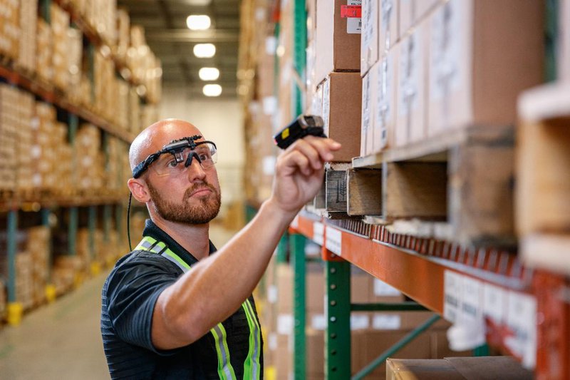 Wearable wearables: smart glasses and a ring scanner help a worker quickly pick stock.