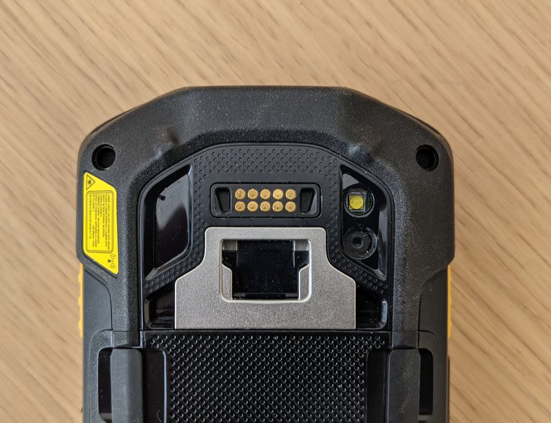 A rugged phone, reverse side, showing the robust charging mechanism, which is a superior option to consumer phone charging options – even if rugged phone cases are used.