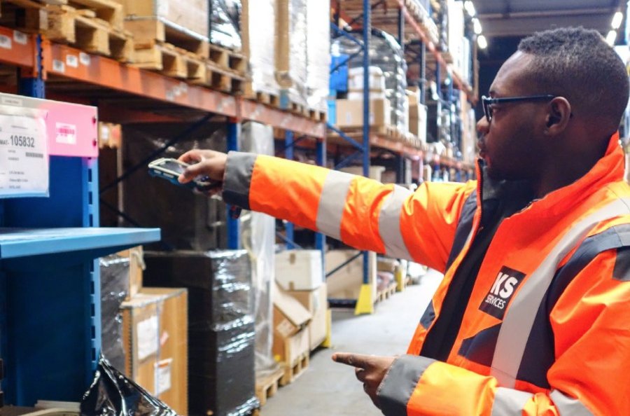 Warehouse worker scanning barcode with rugged mobile device