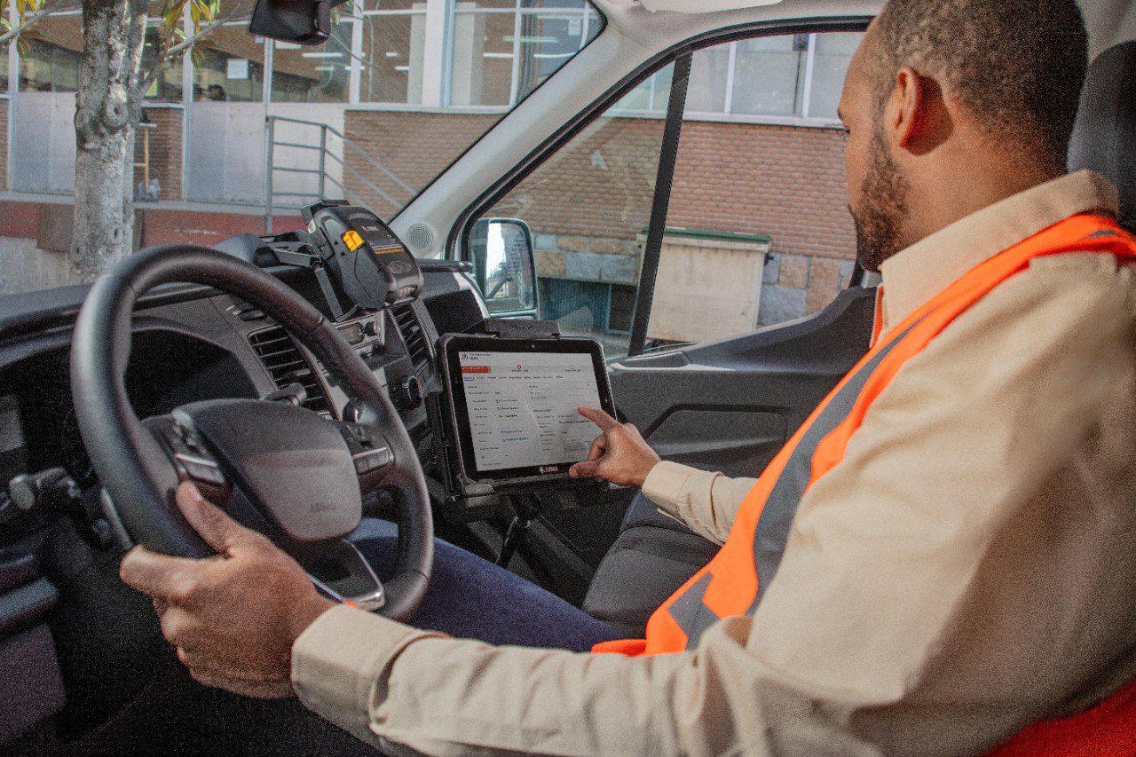 Facilities management worker using a Zebra ET8X tablet mounted in a vehicle