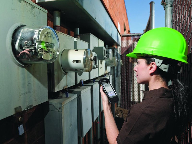 Field service utilities worker using a Zebra TC77 rugged mobile solution to read a meter