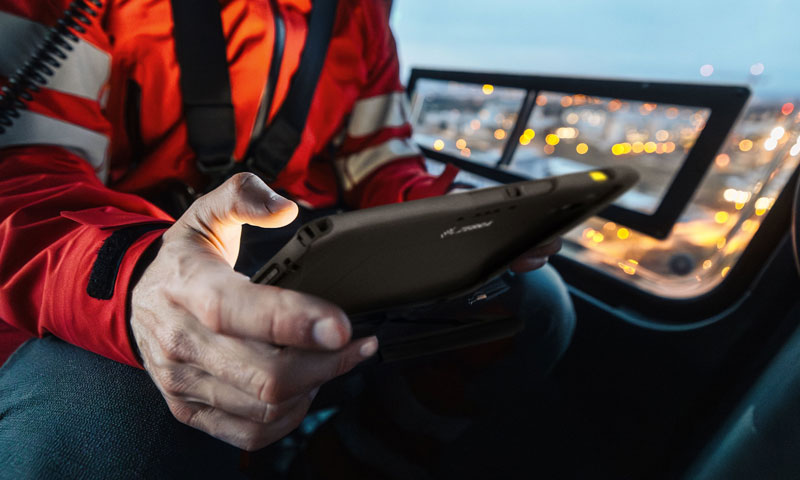 Security worker in vehicle using Zebra rugged phone for data capture